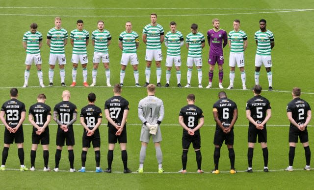 Celtic and Livingston players stand for a minute’s silence 