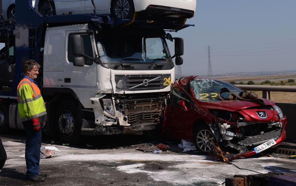 A car transporter ploughed into a red car in one horrific part of the crash. (PA)