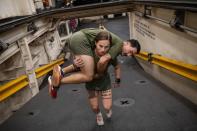 Marines have to be able to carry one another if necessary. USMC Cpl Gabrielle Green hefts a fellow marine as they ready for deployment on a Navy ship at Camp Lejeune, North Carolina. Of the 38,000 recruits who enter the corps each year, about 3,500 are women. (National Geographic/Lynsey Addario)
