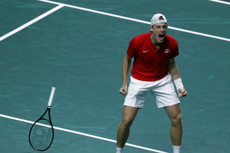 Canada's Denis Shapovalov celebrates after defeating Australia's Thanasi Kokkinakis during the final Davis Cup tennis match between Australia and Canada in Malaga, Spain, Sunday, Nov. 27, 2022. (AP Photo/Joan Monfort)