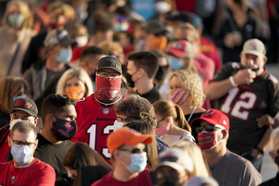 FILE - In this Feb. 4, 2021, file photo, people wait in line for an exhibit at the NFL Experience in Tampa, Fla. The city is hosting Sunday's Super Bowl football game between the Tampa Bay Buccaneers and the Kansas City Chiefs. (AP Photo/Charlie Riedel, File)