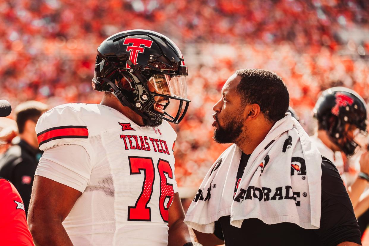 Texas Tech player personnel director James Blanchard, right, confers with offensive tackle Caleb Rogers (76) during a game this season. Blanchard, who oversees a recruiting operation that could sign a top-25 class this month, recently signed a two-year contract worth $220,000 a year.