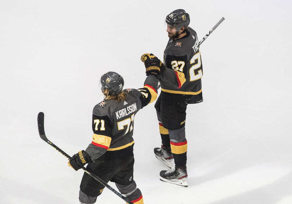 Vegas Golden Knights' William Karlsson (71) and Shea Theodore (27) celebrate a goal against the Dallas Stars during the second period of Game 2 of the NHL hockey Western Conference final, Tuesday, Sept. 8, 2020, in Edmonton, Alberta. (Jason Franson/The Canadian Press via AP)