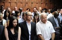 Aimee, Carl and Henke Pistorius attend the appearance of their brother and son South African Olympic sprinter Oscar Pistorius on February 20, 2013 at the Magistrate Court in Pretoria. Pistorius, 26, said he kept a firearm under his bed at night because he had been a victim of violence and burglaries before and had received death threats