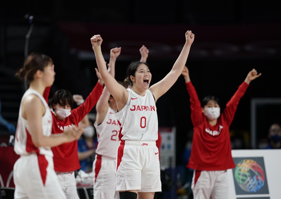 Japan players celebrate their win in the women's basketball preliminary round game against France at the 2020 Summer Olympics, Tuesday, July 27, 2021, in Saitama, Japan. (AP Photo/Charlie Neibergall)