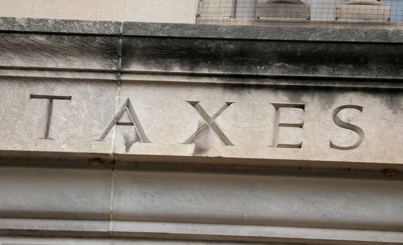 FILE PHOTO: The word "taxes" is seen engraved at the headquarters of the Internal Revenue Service (IRS) in Washington, D.C.