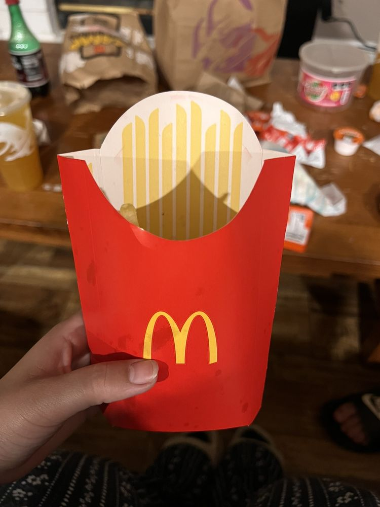 An almost empty McDonald's fry container