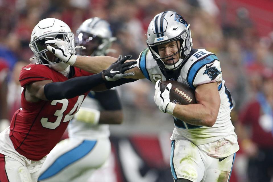 Carolina Panthers running back Christian McCaffrey (22) breaks away from Arizona Cardinals free safety Jalen Thompson (34) during the first half of an NFL football game Sunday, Nov. 14, 2021, in Glendale, Ariz. (AP Photo/Ralph Freso)