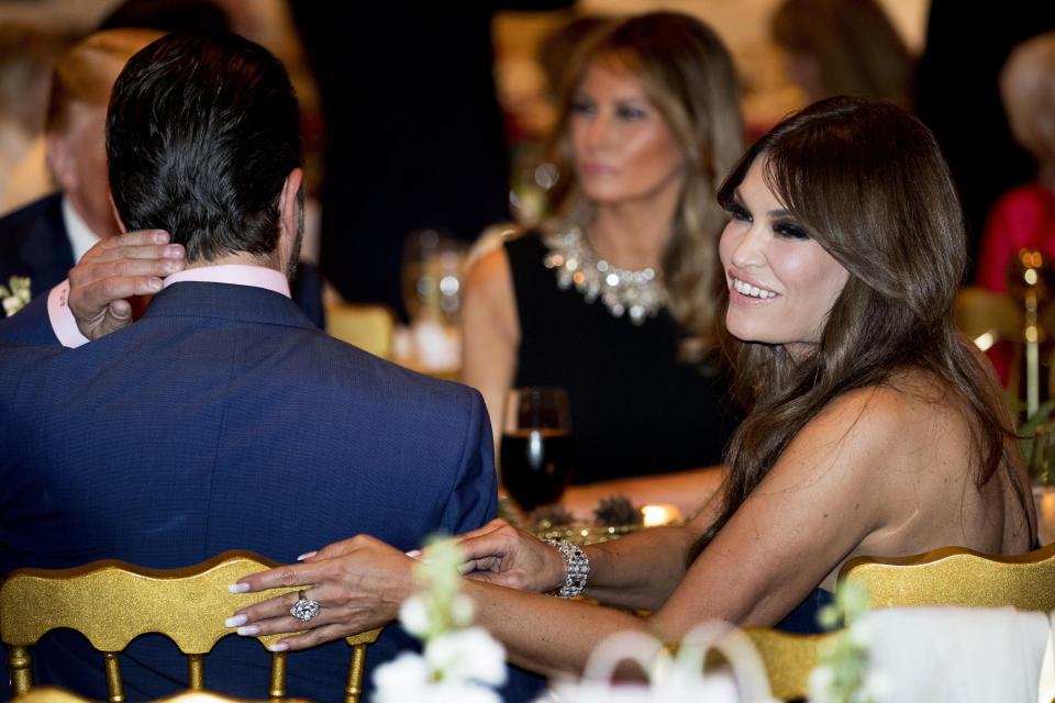Kimberly Guilfoyle, right, and Donald Trump Jr., the son of President Donald Trump, left, sit with President Donald Trump, background left, and first lady Melania Trump, center, during Christmas Eve dinner at Mar-a-lago in Palm Beach, Fla., Tuesday, Dec. 24, 2019. (AP Photo/Andrew Harnik)