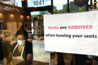 FILE - In this June 17, 2021, file photo, a sign is displayed at a restaurant in Rolling Meadows, Ill. COVID-19 deaths in the U.S. have dipped below 300 a day for the first time since the early days of the disaster in March 2020, while the number of Americans fully vaccinated has reached about 150 million. (AP Photo/Nam Y. Huh, File)