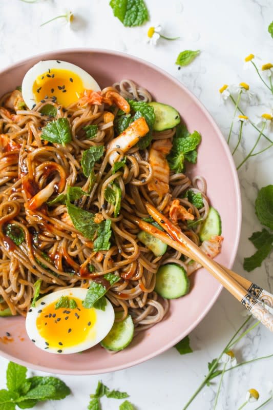 <p>Soba noodles tossed with kimchi, cucumbers and Korean style gochujang sauce then topped with fresh mint. This Korean style kimchi soba noodle is simple, delicious, and perfect for a weeknight dinner.</p><p><strong>Get the recipe: <a href="https://cookingwithawallflower.com/2019/06/09/korean-style-kimchi-soba-noodles/" rel="nofollow noopener" target="_blank" data-ylk="slk:Korean Style Kimchi Soba Noodles;elm:context_link;itc:0;sec:content-canvas" class="link rapid-noclick-resp"><em>Korean Style Kimchi Soba Noodles</em></a></strong></p>