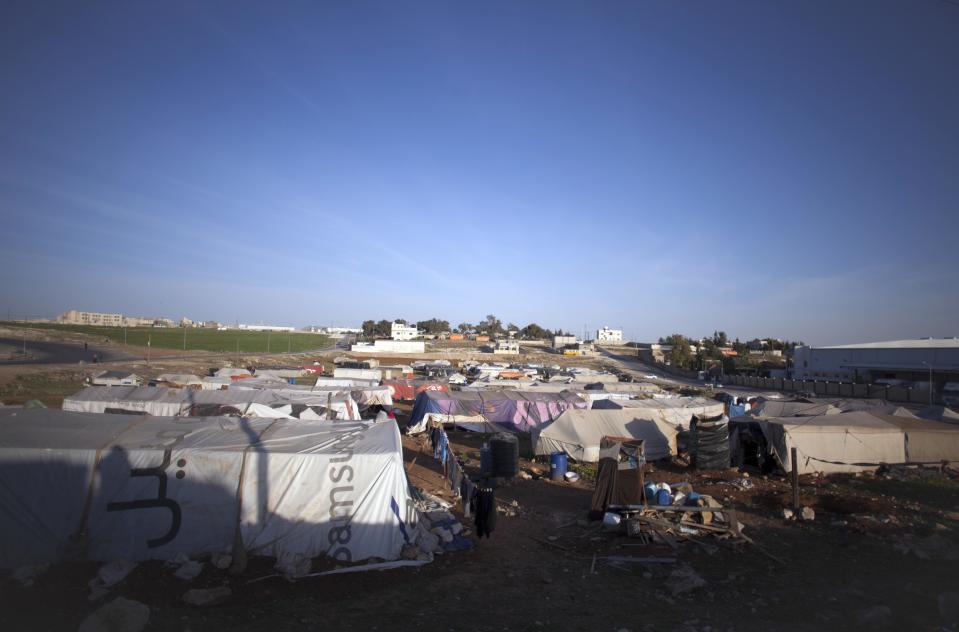 This Friday, April 5, 2014 photo shows a general view of an unofficial Syrian refugee camp on the outskirts of Amman, Jordan. Some residents, frustrated with Zaatari, the region's largest camp for Syrian refugees, set up new, informal camps on open lands, to escape tensions and get closer to possible job opportunities.(AP Photo/Khalil Hamra)