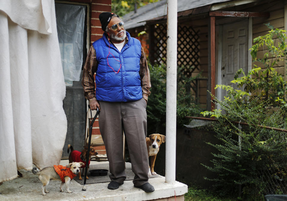Charles Shields, 71, stands on his front porch with his dogs on election day in Atlanta, Tuesday, Nov. 6, 2018. "I didn't see a reason to vote. I feel like if I vote it really does no good. I feel like I don't really get a fair deal either way it goes," said Shields who voted once in a mayoral race. "I feel like a new man going in is a good man but when he get in there that's when he turns into a different person. I've heard just about everything they could say," he adds about whether any candidate in the future would inspire him enough to vote. "What I usually do is get a sign of who I like and ride around with it on my car so I feel like that is helping." (AP Photo/David Goldman)