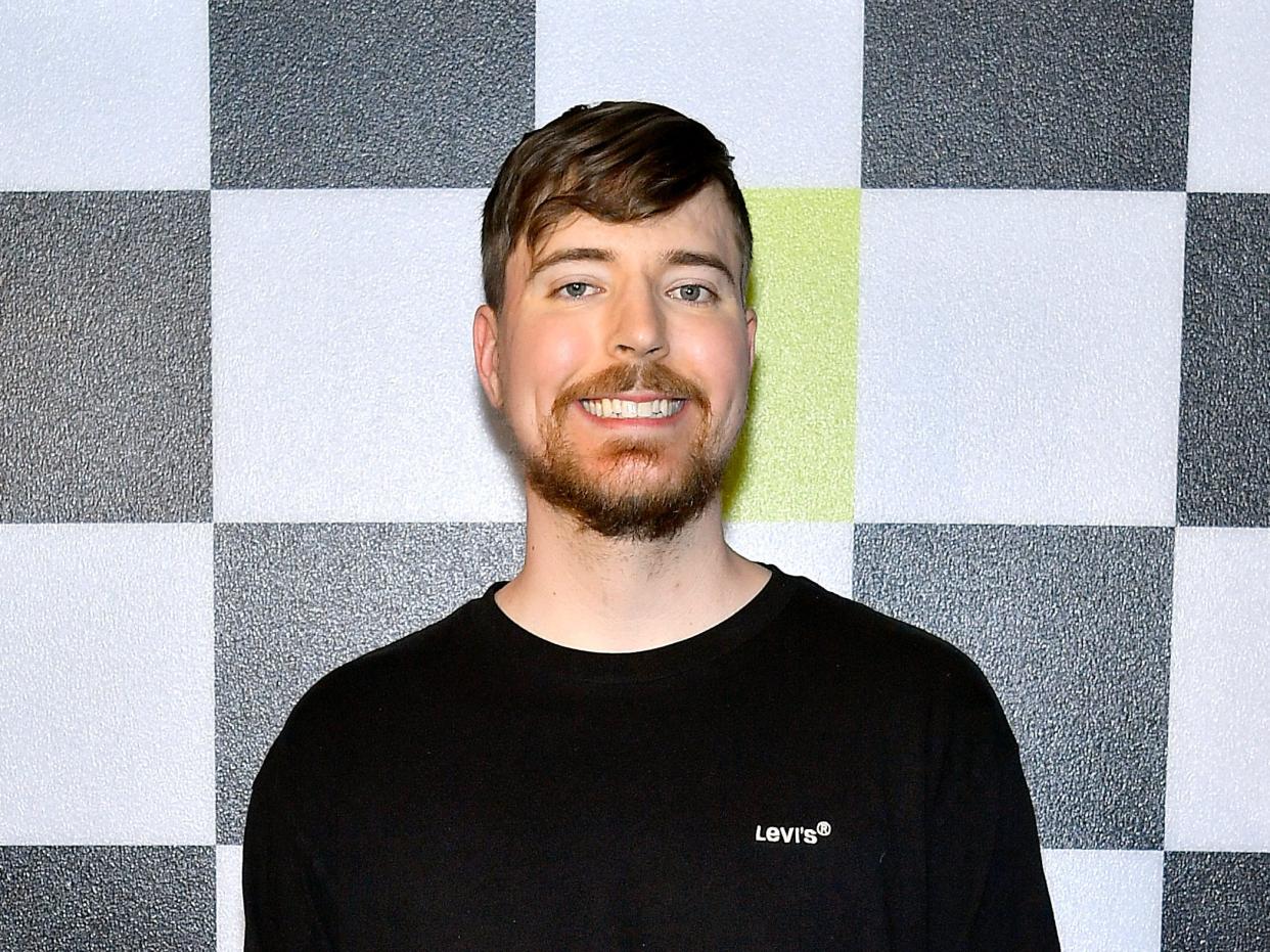 MrBeast smiling in front of checkered background at YouTube Broadcast event.