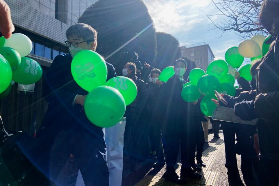 Supporters of six plaintiffs who were children at the time of the 2011 Fukushima nuclear plant disaster stand outside a court in Tokyo on 27 January  (AP)