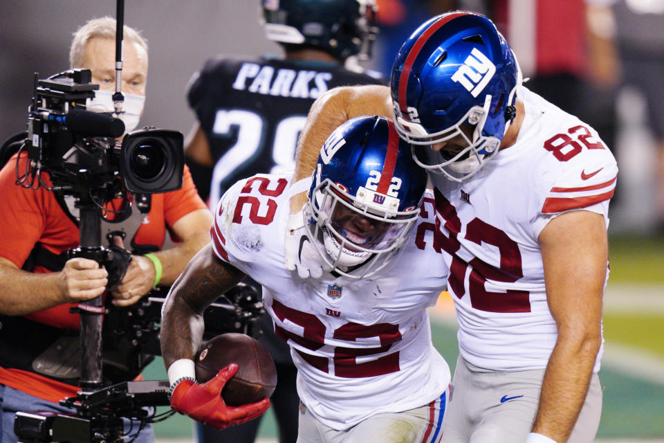 New York Giants' Wayne Gallman (22) and Kaden Smith (82) celebrate after Gallman's touchdown during the second half of an NFL football game against the Philadelphia Eagles, Thursday, Oct. 22, 2020, in Philadelphia. (AP Photo/Chris Szagola)