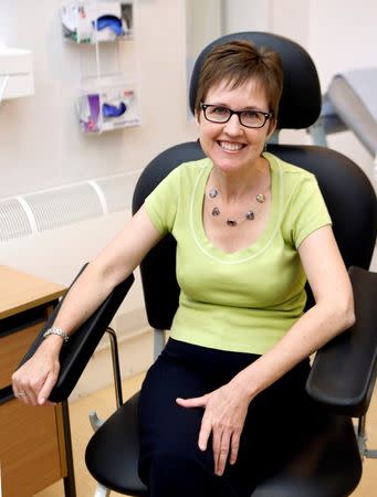 Volunteer Ruth Atkins poses for a photograph before receiving an injection of the Ebola vaccine, at the Oxford Vaccine Group Centre for Clinical Vaccinology and Tropical Medicine (CCVTM) in Oxford, southern England September 17, 2014. REUTERS/Steve Parsons/Pool