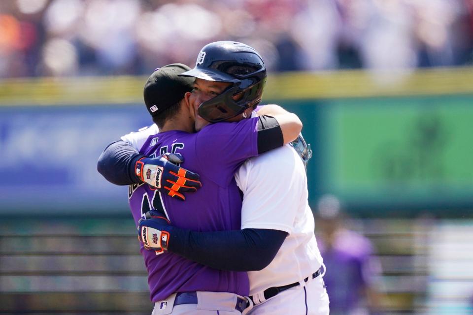 Detroit Tigers designated hitter Miguel Cabrera is greeted Colorado Rockies shortstop Jose Iglesias after his 3,000th career hit during the first inning of the first baseball game of a doubleheader against the Rockies, Saturday, April 23, 2022, in Detroit.