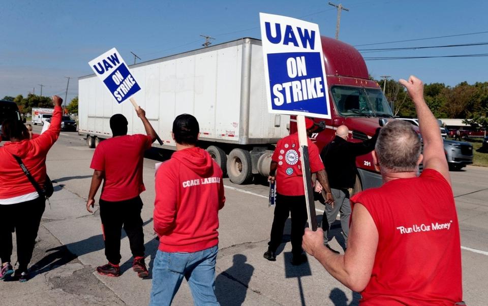 Striking Ford Motor Co. employees represented by the UAW and Local 900 picket on the sidewalk across the entrance to Gate 9 at the Michigan Assembly in Wayne blocking independent truck drivers from getting into the plant on Friday, Sept. 15, 2023. A member of the Teamsters told the truckers that the strikers would remain all day and that it would be impossible for them to pull in for their deliveries or pickups.