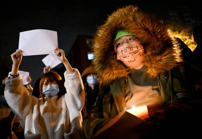 Protesters march during a rally for the victims of a deadly fire as well as a protest against China's harsh COVID-19 restrictions in Beijing on Nov. 28, 2022.