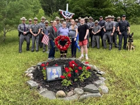 Members of New York State Police and family members of state Trooper Christopher Skinner gather for a memorial service Wednesday, May 29, 2024 along Interstate 81 in Broome County to mark the 10th anniversary of Skinner's death.