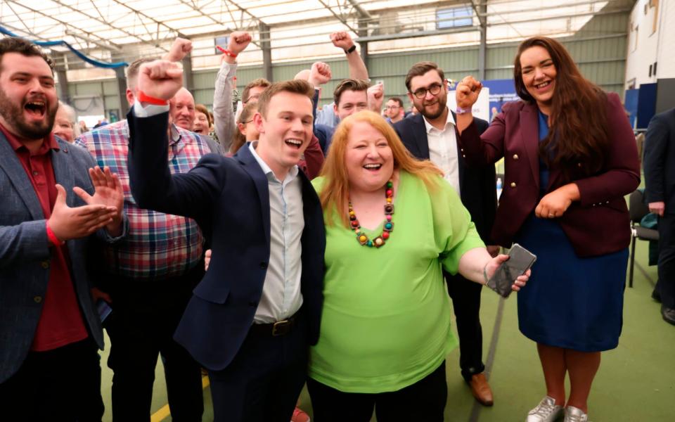 Naomi Long, centre, leader of the Alliance party celebrates with party members  - AP