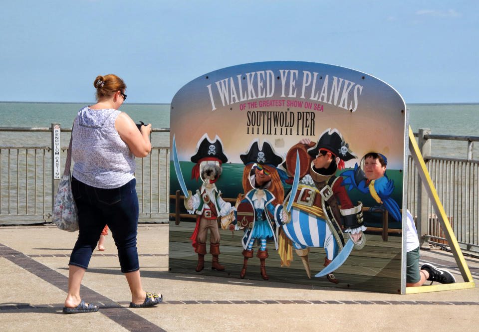  A woman takes a photo of 'I walked ye planks' fun pirate pop up on the Pier.
With the beaches in England now fully opened with only social distancing measures in force, people are taking the chance to visit some coastal resorts.
Southwold is an English resort town full of an olde world charm and famous for its 300 brightly coloured beach huts. Plenty of people were out and about on the sandy beach and on the pier. (Photo by Keith Mayhew / SOPA Images/Sipa USA) 