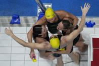 The team from Australia celebrates after winning the final of the women's 4x100m freestyle relay at the 2020 Summer Olympics, Sunday, July 25, 2021, in Tokyo, Japan. (AP Photo/Morry Gash)