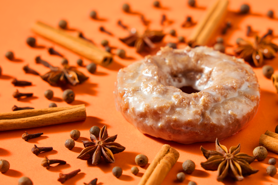 The Pumpkin Spice Cake Doughnut and Pumpkin Spice Latte are available now at Krispy Kreme. The doughnuts will also be available in select retailers in a 6-pack.