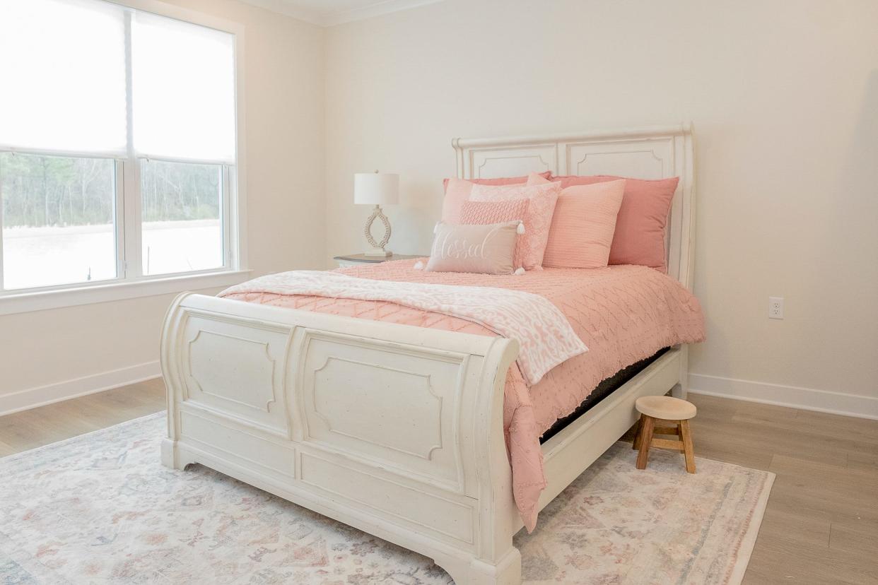 The primary bedroom uses subtle shades of mauve as the key color palette.