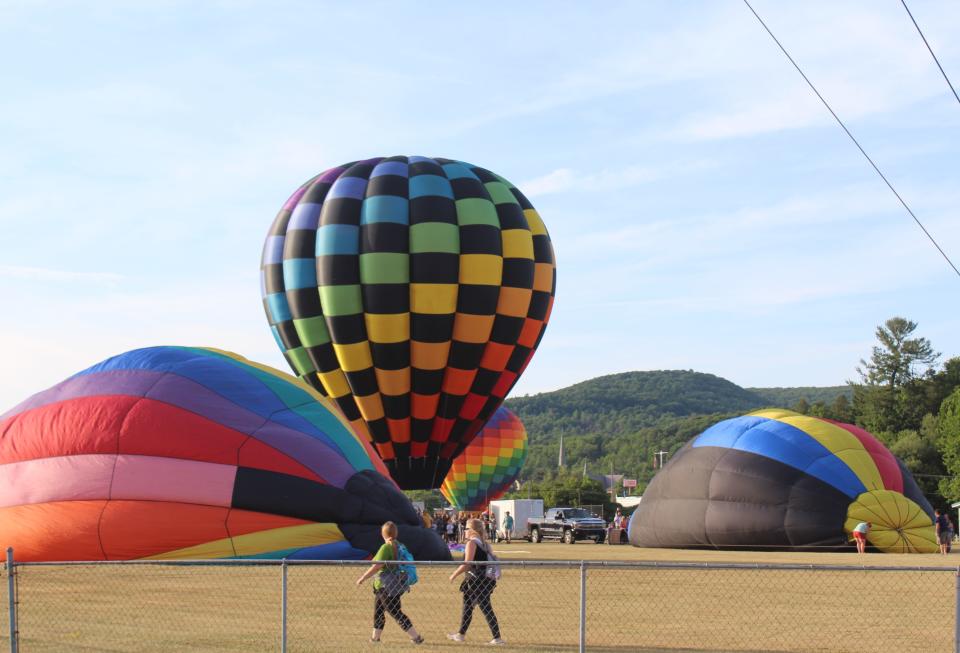 The Great Wellsville Balloon Rally lifts off in July 2022 under calm conditions as several dozen hot air balloons took to the sky.
