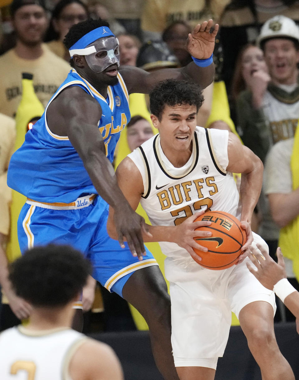 FILE - Colorado forward Tristan da Silva, right, pulls in a rebound as UCLA forward Adem Bona defends in the first half of an NCAA college basketball game, Sunday, Feb. 26, 2023, in Boulder, Colo. (AP Photo/David Zalubowski)