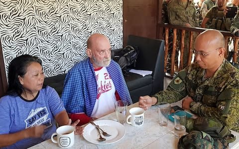 Philippine Maj. Gen. Corleto Vinluan, right, talks to rescued British national Allan Hyrons, center, and his Filipino wife Wilma inside a military camp at Jolo, Sulu province, southern Philippines  - Credit: Armed Forces of the Philippines, Task Force Sulu