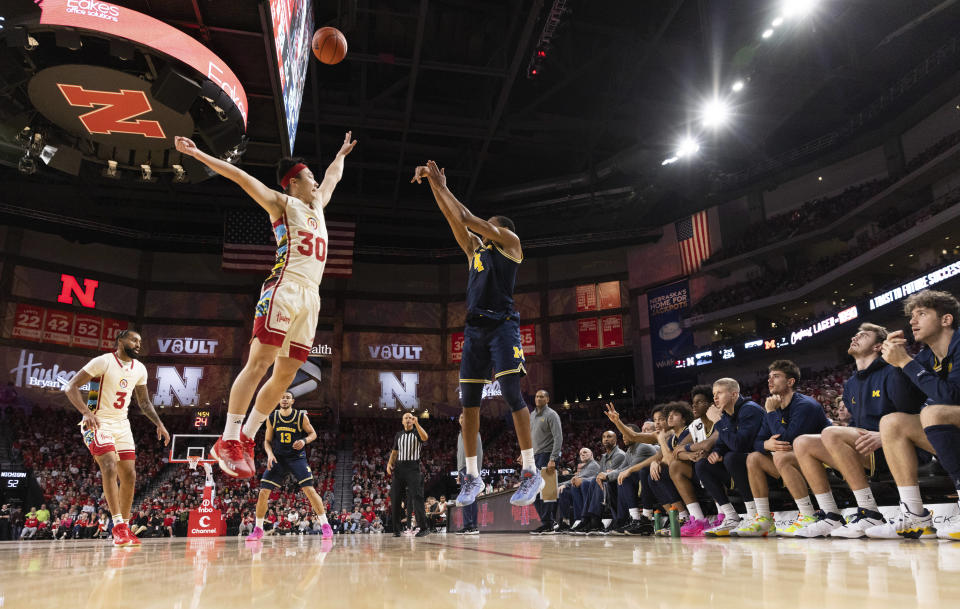 Michigan's Nimari Burnett (4) shoots a 3-point basket against Nebraska's Keisei Tominaga (30) during the second half of an NCAA college basketball game Saturday, Feb. 10, 2024, in Lincoln, Neb. (AP Photo/Rebecca S. Gratz)