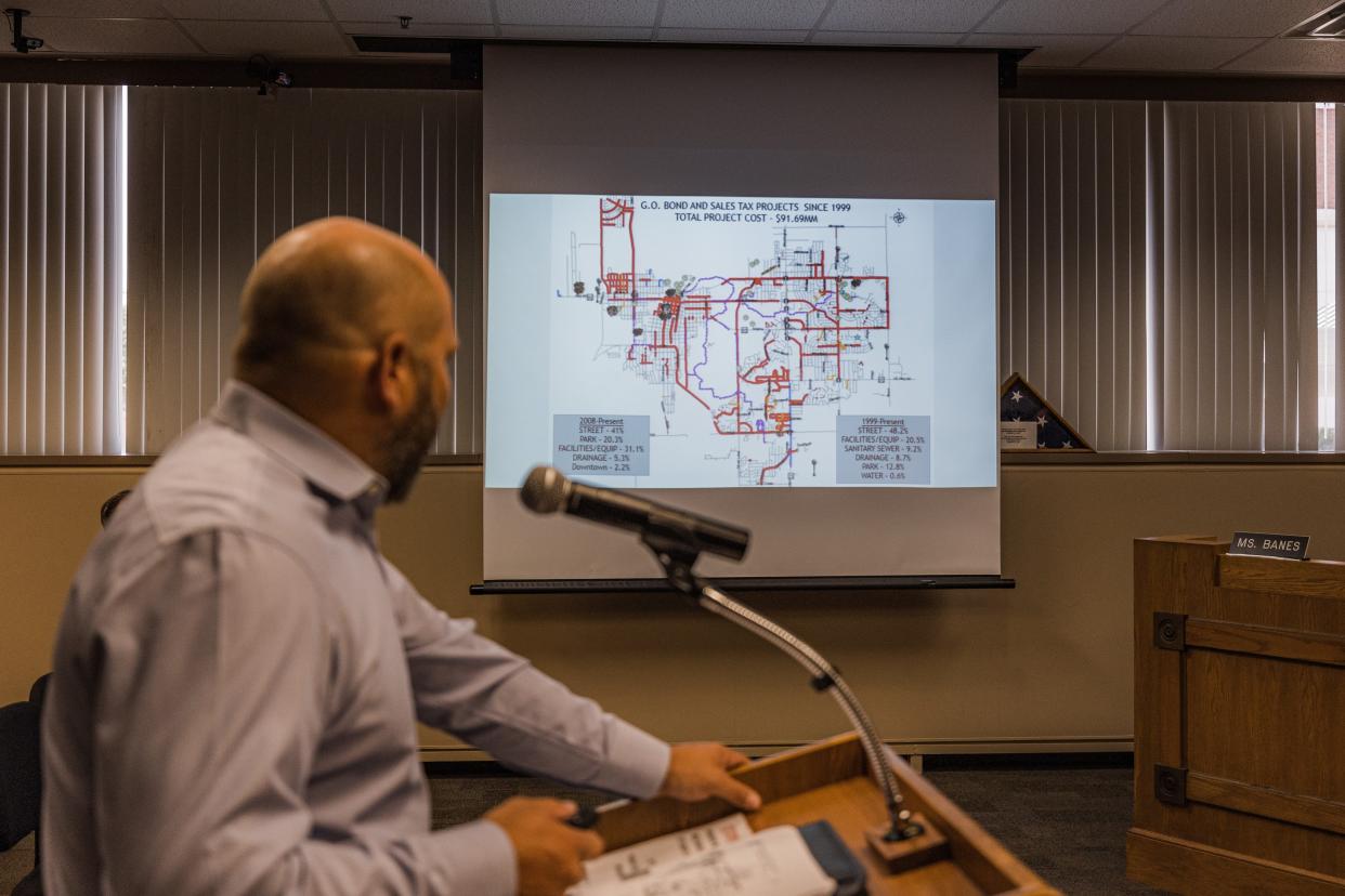 Micah Siemers, director of engineering, presents a map showing all the road improvements made since 1999 totaling $91.69 million.