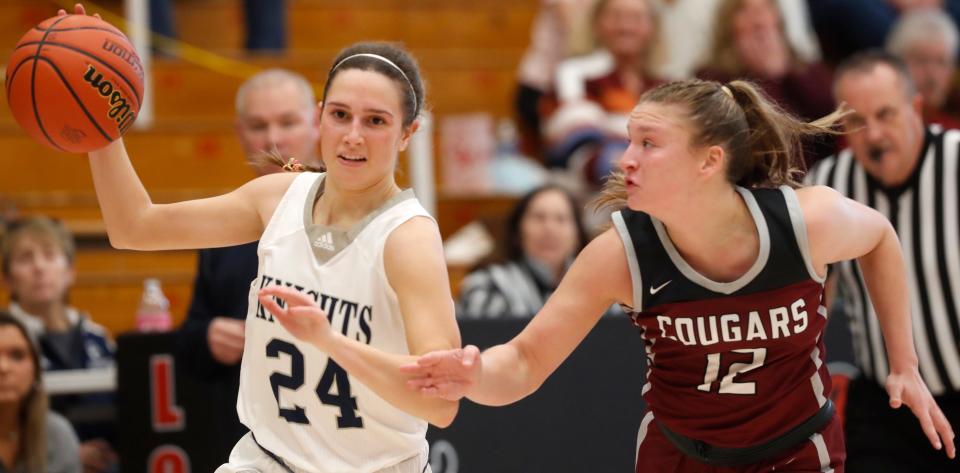 Central Catholic Knights Carley Barrett (24) drives pst Central Noble Cougars forward Meghan Kiebel (12) during the IHSAA girl’s basketball semi state game, Saturday, Feb. 18, 2023, at the Berry Bowl in Logansport, Ind. Central Noble won 43-42.