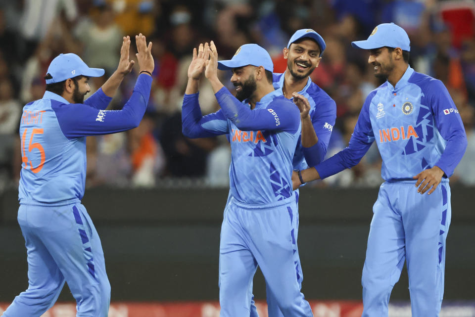India's Virat Kohli, second left, is congratulated by teammates after taking a catch to dismiss Zimbabwe's Wesley Madhevere during the T20 World Cup cricket match between India and Zimbabwe in Melbourne, Australia, Sunday, Nov. 6, 2022. (AP Photo/Asanka Brendon Ratnayake)