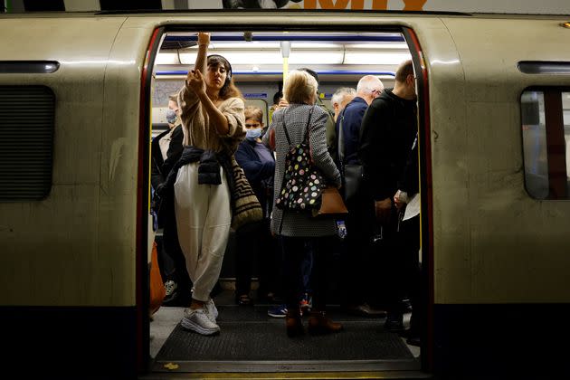 <strong>Commuters, some wearing face coverings to help prevent the spread of coronavirus, wait for the Tube.</strong> (Photo: TOLGA AKMEN via Getty Images)