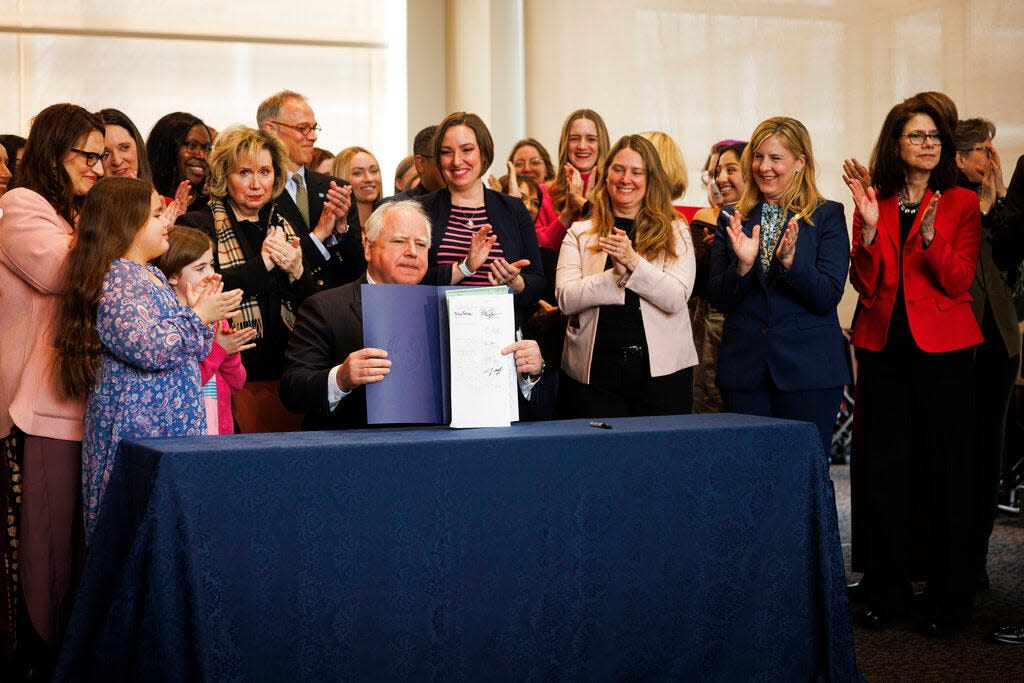 Gov. Tim Walz signs the PRO Act during a ceremony on Tuesday, Jan.  31, 2023, at the Minnesota Department of Revenue in St. Paul, Minn.