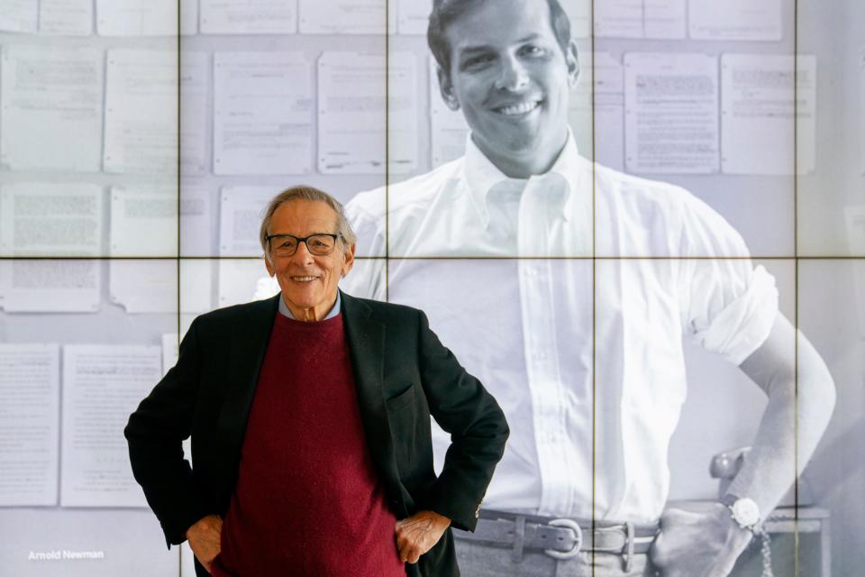 Author and biographer Robert Caro stands beside an image of his younger self after touring a permanent exhibit in his honor, "Turn Every Page": Inside the Robert A. Caro Archive, at the New York Historical Society Museum & Library in New York on Oct. 20, 2021.