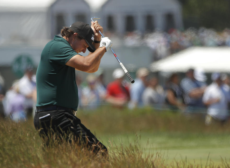 Phil Mickelson reacts to a shot from the fescue on the fifth hole during the third round of the U.S. Open. (AP)