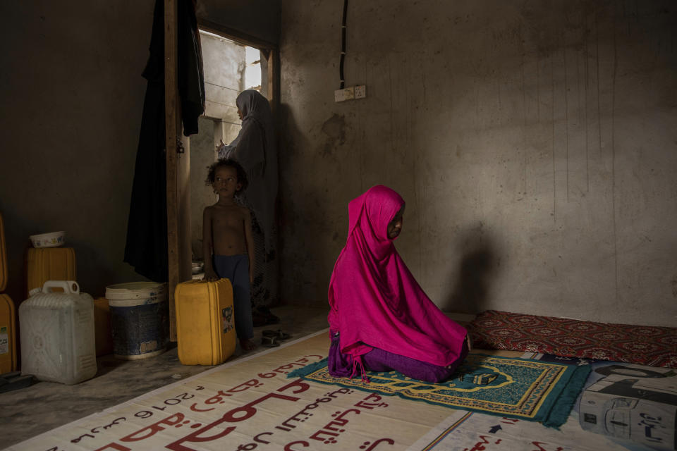 In this July 20, 2019 photo, a 17-year-old Ethiopian migrant, a victim of rape, prays in Basateen, a district of Aden, Yemen. She says she had been raped more times than she can count. The first time was during the boat crossing from Djibouti, packed in with more than 150 other migrants. Fearing the smugglers, no one dared raise a word of protest as the captain and his crew raped her and the other nine women on board during the eight-hour journey. (AP Photo/Nariman El-Mofty)