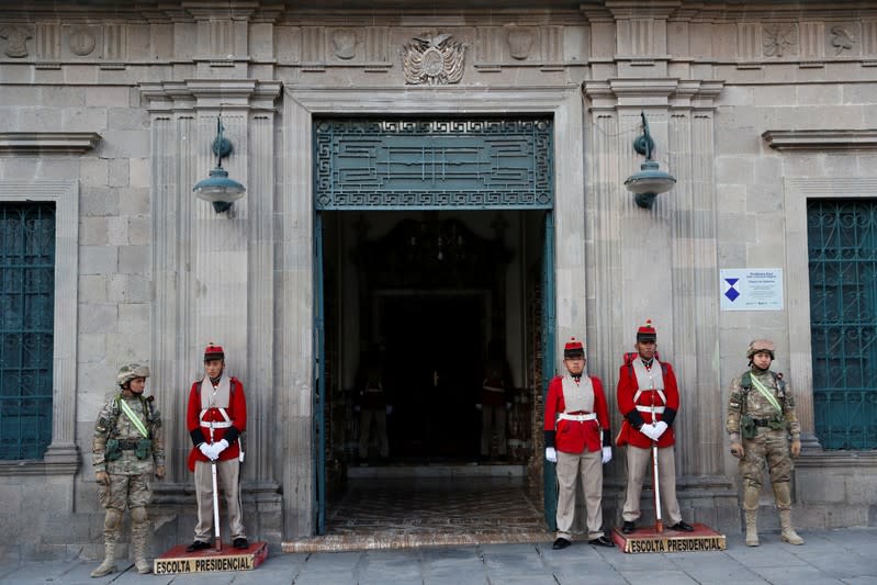 Military members stand guard at an entrance of the Presidential Palace in La Paz