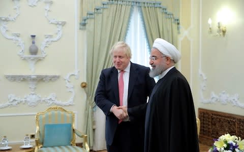 Iranian President Hassan Rouhani greets then-Foreign Secretary Boris Johnson at the start of their meeting in Tehran in 2017 - Credit: AP