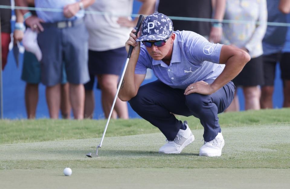 Rickie Fowler lines up his putt on the 18th green during the second round of the Wyndham Championship golf tournament, Friday, Aug. 5, 2022, in Greensboro, N.C. (AP Photo/Reinhold Matay)