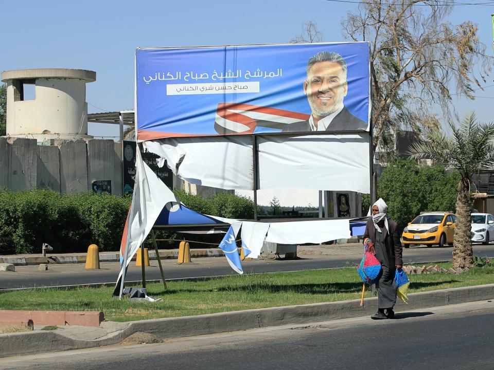 Electoral posters for the upcoming parliamentary elections are seen torn in Baghdad, Iraq, Sunday, Sept. 26, 2021. (AP Photo/Hadi Mizban)