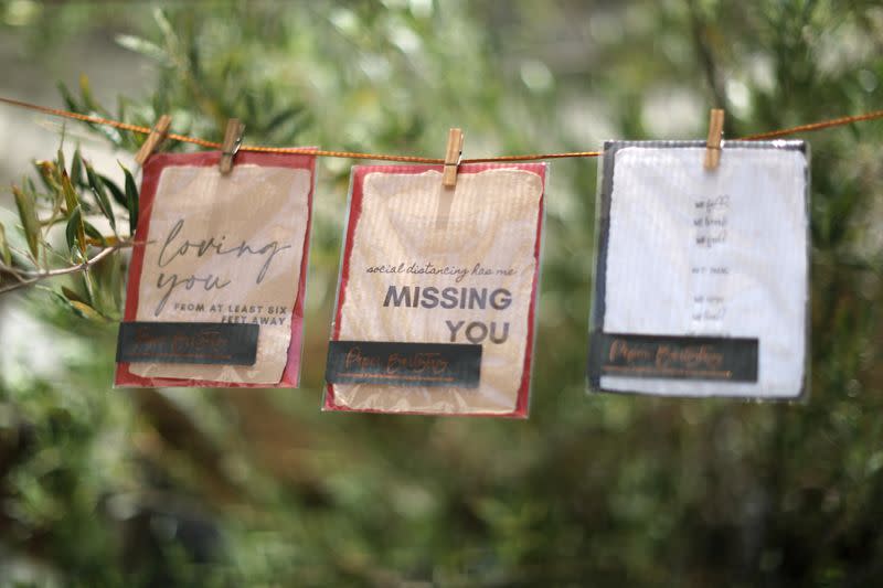 Cards with social distancing-related greetings hang outside the Lady Byrd Cafe in Los Angeles