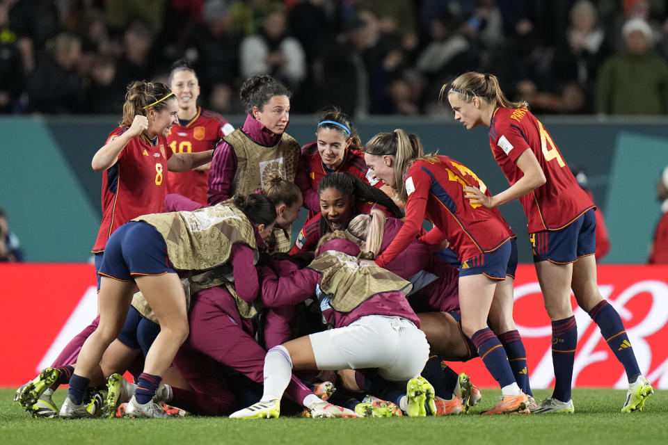 Spain's Olga Carmona is celebrates by her teammates after she scored her side's winning goal during the Women's World Cup semifinal soccer match between Sweden and Spain at Eden Park in Auckland, New Zealand, Tuesday, Aug. 15, 2023. (AP Photo/Alessandra Tarantino)