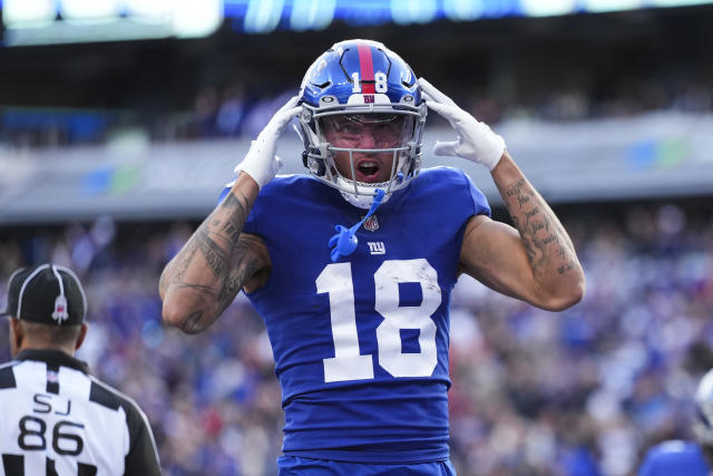 Isaiah Hodgins of the New York Giants runs the ball while being News  Photo - Getty Images