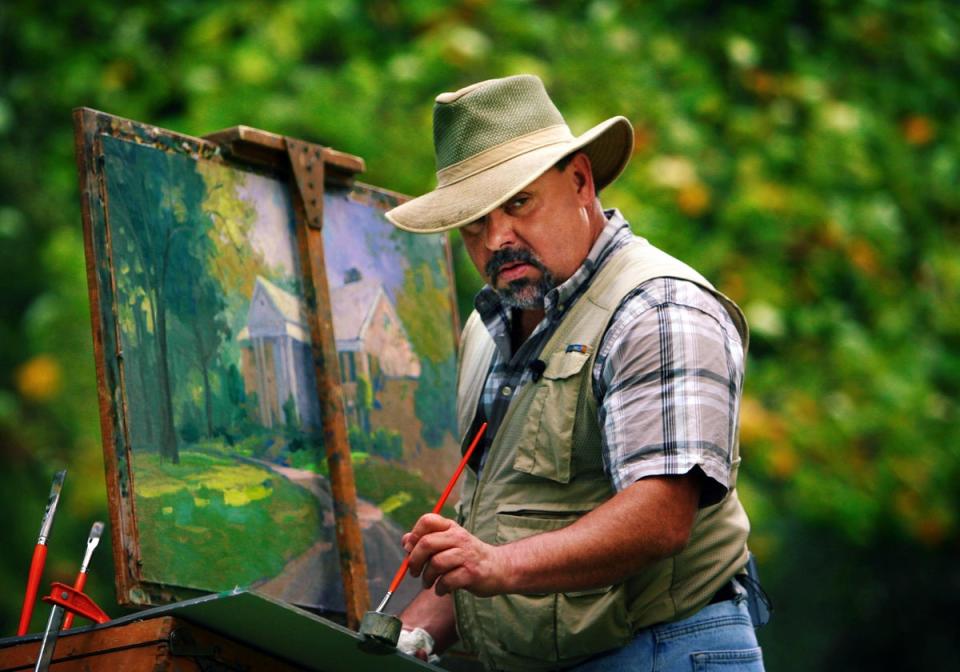 California painter Thomas Kinkade built an art empire known for serene scenes featuring a characteristic glow; he was nicknamed the ‘Painter of Light’ (Alamy Stock Photo)